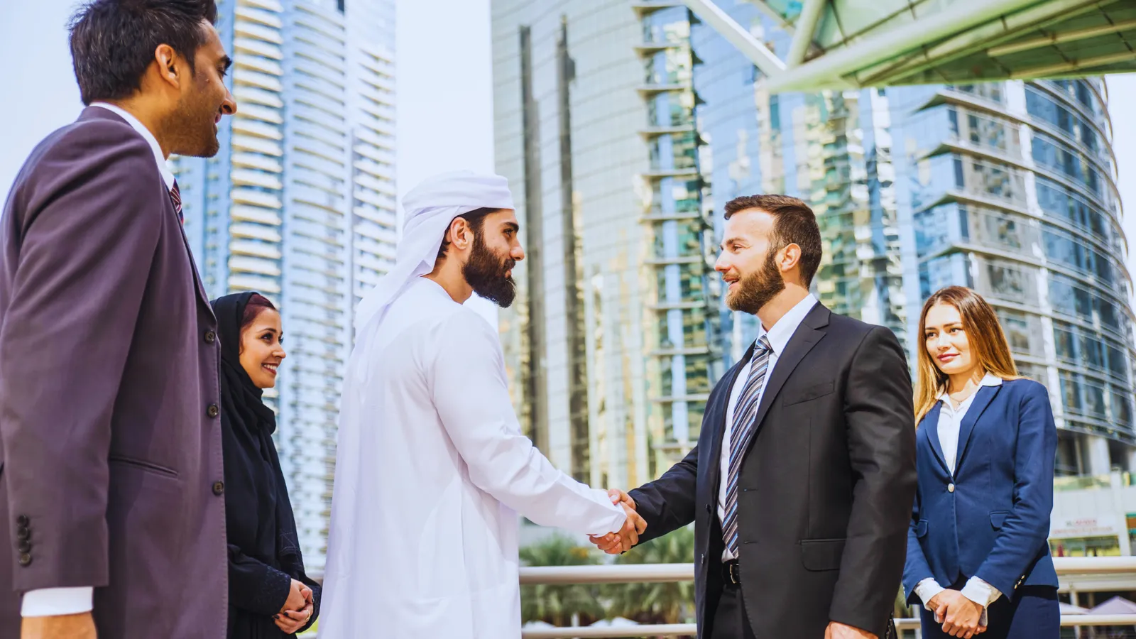 Business professionals discussing company formation in Dubai and transitioning a Free Zone company registration Dubai to a mainland setup.