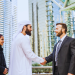 Business professionals discussing company formation in Dubai and transitioning a Free Zone company registration Dubai to a mainland setup.